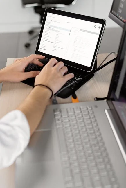 Businesswoman working on laptop with Android 6.0 Marshmallow webpage open.